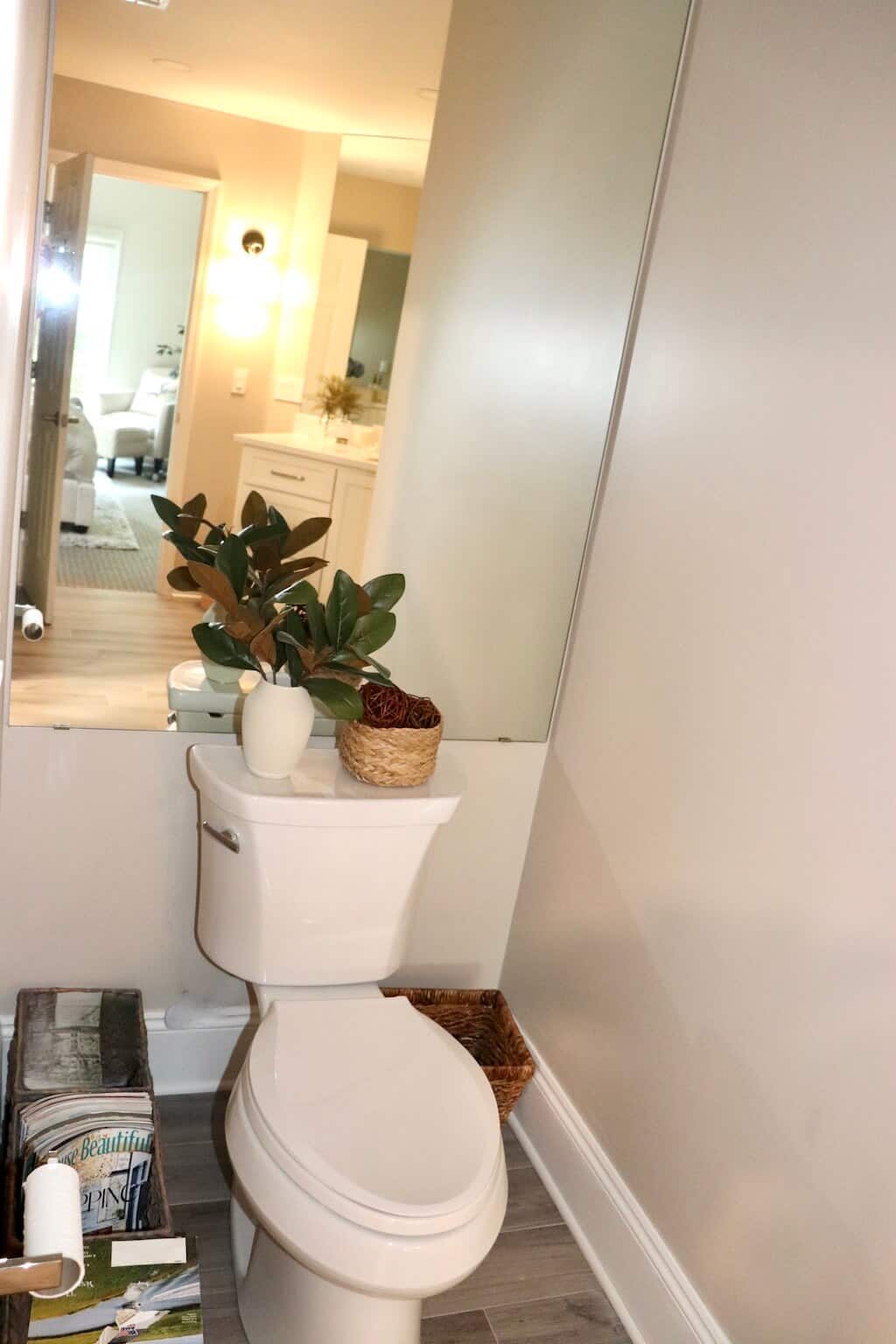 Mirror Behind Toilet in Master Bathroom Provides Space Illusion for Mirror Magic