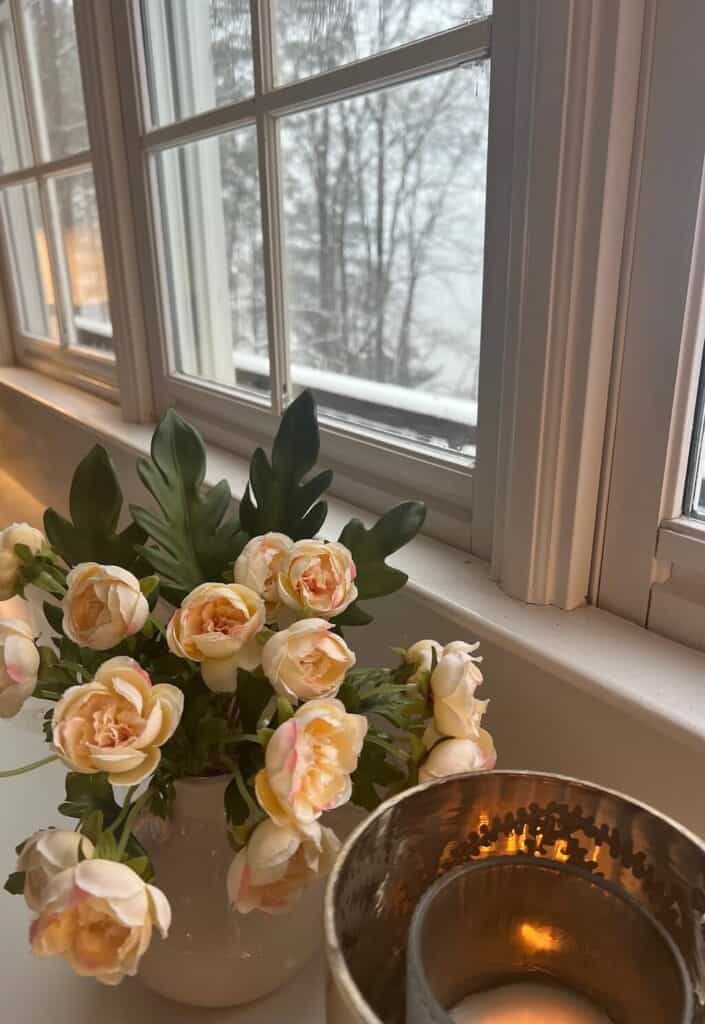 Flowers and candle with a snow day background
