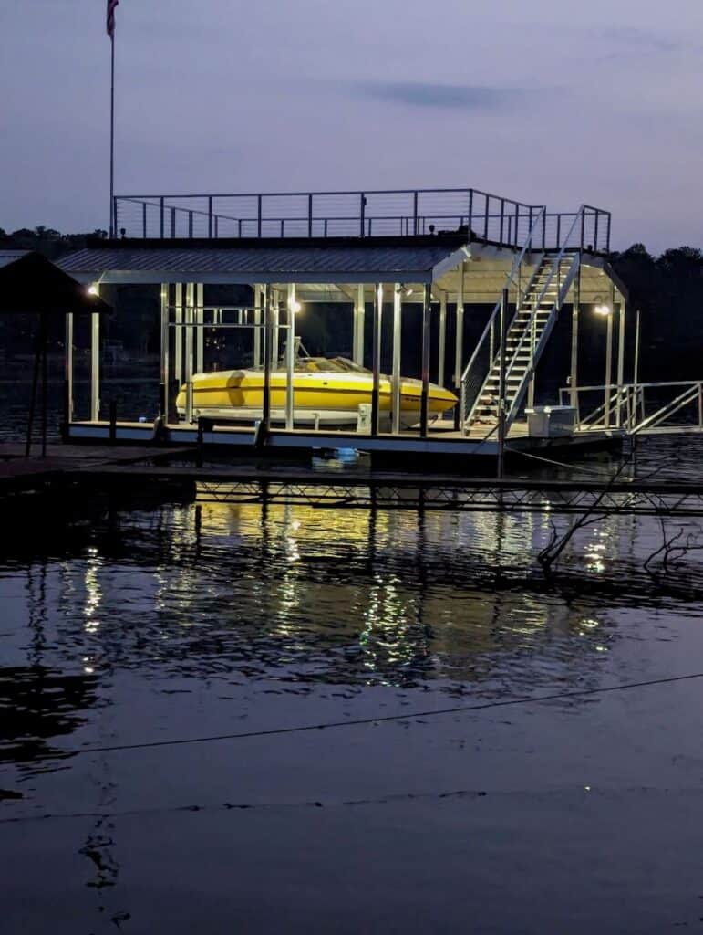 The new dock with the new old boat lit up at night