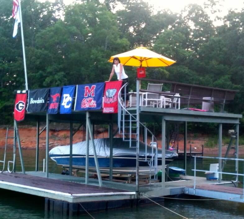 Our Parent's Dock with Mom and all the college flags
